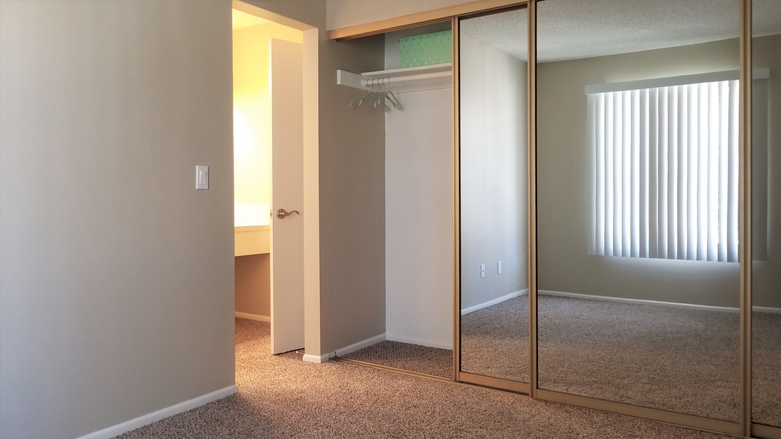 Spacious bedroom with sliding closet doors