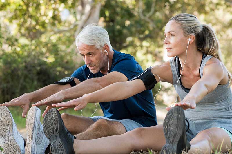 Couple at a park stretching